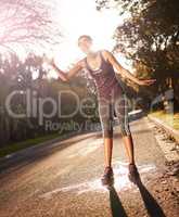 That after workout feeling.... Shot of a young woman pouring cold water over her head after an intense workout.