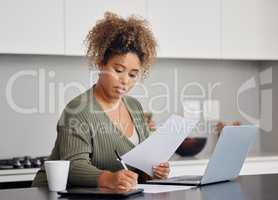 Life can wait, get distracted. Shot of a woman filling in some paperwork at home.