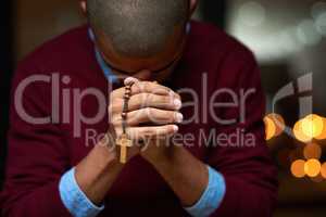 Hell answer all your prayers. Cropped shot of a man holding a rosary and praying.