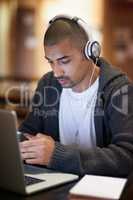 Im studying in the library if you want to join. Cropped shot of a college student texting on his cellphone while working at campus.