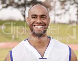 Happiness is being able to play sports. Shot of a handsome young man standing alone outside while playing sports.