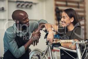I fixed it faster this time. Shot of two young business owners standing together in their bicycle shop during the day.