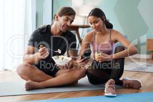 Your diet is just as important as your workout. Full length shot of an athletic young couple enjoying some healthy snacks after their workout at home.