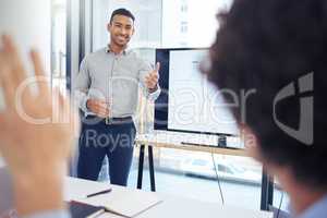 Whats your question. Shot of a young businessman raising his hand to ask a question in a meeting at work.