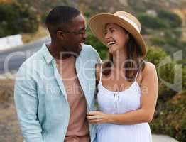 Theres something special in the air. Shot of a happy young couple enjoying a romantic road trip.