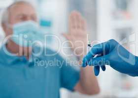 Are there any risks. Cropped shot of a senior man gesturing to stop an unrecognizable doctor from injecting him with the covid 19 vaccine.