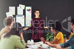 Impressing the team with her ideas. Cropped shot of a young creative giving a presentation to her colleagues in an office.