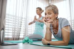 Ive had enough thanks. Shot of two mature women exercising together at home.