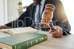 We need order in here. Shot of an unrecognizable lawyer using a gavel at work.