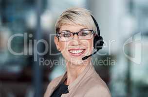 When you call, we answer immediately. Portrait of a young businesswoman wearing a headset while working in an office.