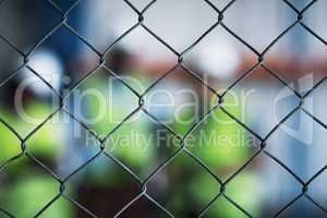 Keep your site secure at all costs. Shot of a group of unrecognisable builders inspecting a construction site behind a fence.