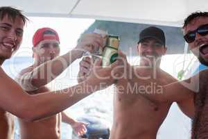 Enjoying their guys getaway. Portrait of a group of guys drinking beer while on a boat at sea.