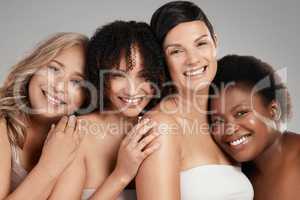 You grow where you feel accepted. Shot of a diverse group of women standing and hugging each other in the studio.