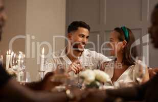 Im so glad were here together. Shot of a happy young couple sitting together and bonding during a New Years dinner party.