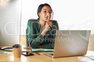 Keep that info to yourself. Shot of a young businesswoman using her laptop to host a video conference at work.