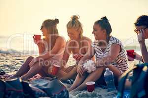 Good times and tan lines. Shot of young female best friends hanging out at the beach.