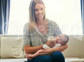 Its in my nature to nurture. Shot of a young mother and her baby at home.
