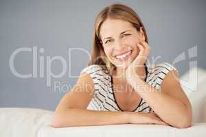 Home is where her heart is. Portrait of a young woman relaxing on the sofa at home.