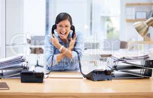 I need a break this is too much. Shot of a young businesswoman screaming in frustration at her telephone.