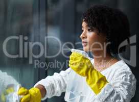 I guess its time to clean my windows. Shot of a young woman cleaning her windows.