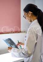 Your oral health is intrinsically linked to your general health. Cropped shot of a young female dentist analysing an x-ray.