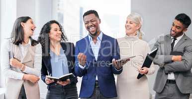 Celebrating the best parts of life. Shot of a team of businesspeople together at work.