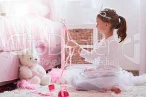 Magical moments. Shot of a little girl dressed up as a princess while playing make believe.