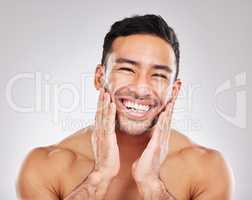 Softness of a macho man. Cropped studio portrait of a handsome young man posing against a grey background.