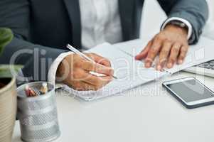 No familiar vibes on my time, Im all new. Shot of unrecognizable businessman doing paperwork at desk.