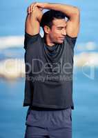 Stretching well encourages your blood to flow more. Shot of a sporty young man stretching his arms while exercising outdoors.