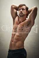 Dangerously hot abs. Shot of a handsome and muscular young man posing shirtless in the studio.