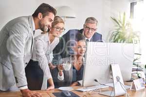 Getting the insight they need to plan a successful year. Shot of businesspeople working together on a computer in an office.