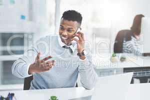 Always try to follow up on every task youve actioned. Shot of a young businessman making a phone call at his office desk with a colleague working in the background.
