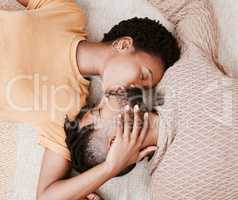 Every kiss is like the first. Aerial shot of a young couple kissing at home.