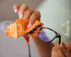 Now I can see clearly again. Shot of an unrecognizable person cleaning glasses at home.