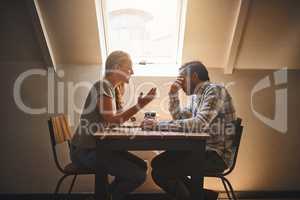 Perfect relationships do not exist but true love does. Shot of a couple having a disagreement at a cafe.