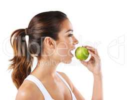 Everyday is a choice. Cropped shot of a healthy young woman eating an apple.