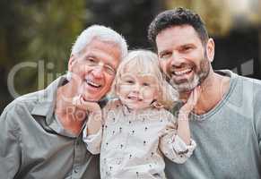This is Dad and Grandad. Shot of a little boy posing outside with his father and grandfather.