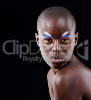 A wild and colorful spirit. Studio portrait of a beautiful model posing with colorful eye makeup on a black background.