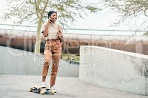 There are no shortcuts to any place worth going. Shot of an attractive young female student using her mobile phone while skateboarding on campus.