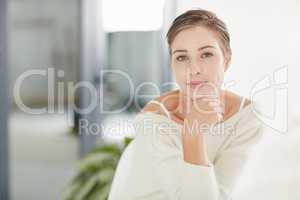 Being happy never goes out of style. Portrait of a smiling young woman alone at home.