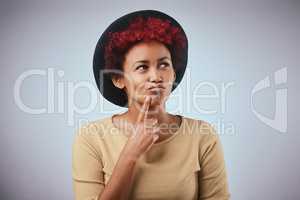 Whatever you decide, make sure it makes you happy. Studio shot of a beautiful young woman contemplating against a grey background.