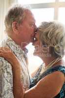 The language of love needs no words. Shot of a senior man tenderly kissing his wifes forehead at home.