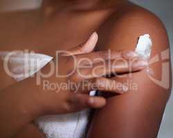 Lack of moisture is the first step to damaged skin. Shot of a woman applying lotion to her body.