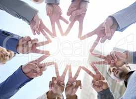 Shining together. Shot of a group of unrecognizable businesspeople making a star shape with their hands.