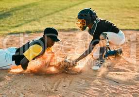 Sliding his way to victory. Shot of a baseball player sliding to the base during a baseball game.