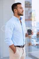 I love my beautiful city. Shot of a young businessman taking a break to drink some coffee while enjoying the view.