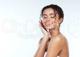 The smile of a woman is the most beautiful curve on her body. Studio shot of an attractive young woman posing against a white background.