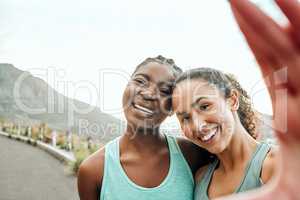 Documenting our fitness journey. Shot of two young women taking a selfie while exercising in nature.