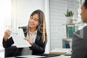 Please read this carefully before you sign. Shot of a female lawyer helping her client sign a contract.